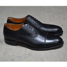 A Berwick 1707 black leather toe cap oxford shoe with a goodyear welted construction and single leather sole.