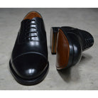 A Berwick 1707 black leather toe cap oxford shoe with a goodyear welted construction and single leather sole.