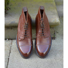 A Berwick 1707 dark brown, premium grain leather lace-up boot with a cap toe and a low heel & Dainite Sole