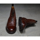 A Berwick 1707 dark brown, premium grain leather lace-up boot with a cap toe and a low heel & Dainite Sole