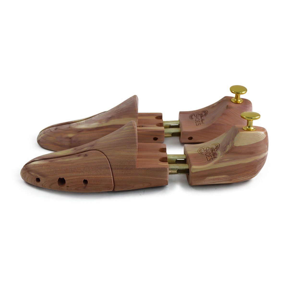A pair of uncompressed cedar wood shoe trees with brass fitments, displayed in an open position.