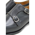 A Berwick 1707 lack double monk shoe with two buckle straps, made from calf leather and featuring a Goodyear welted leather sole.