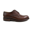 A dark brown, grainy-textured leather derby shoe with a round toe and classic lace-up closure.