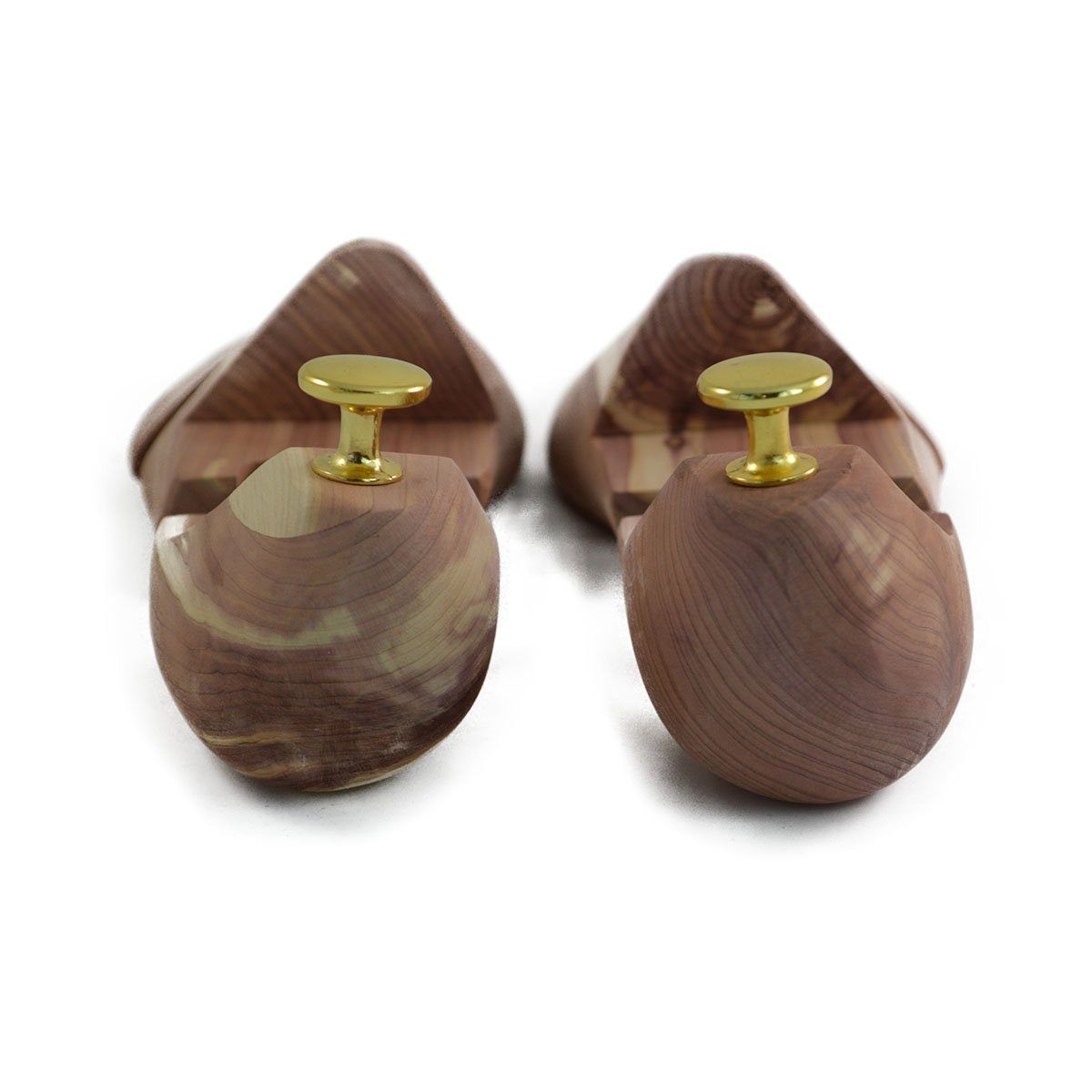 A pair of uncompressed cedar wood shoe trees with brass fitments, displayed in an open position.