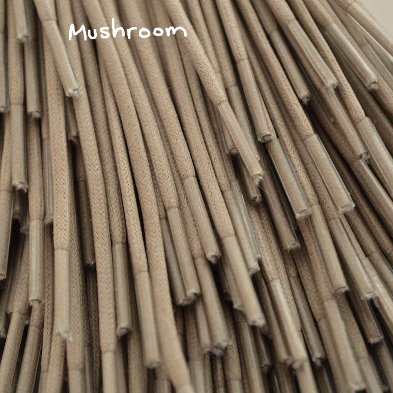 A close-up of a brown waxed round dress shoe lace.