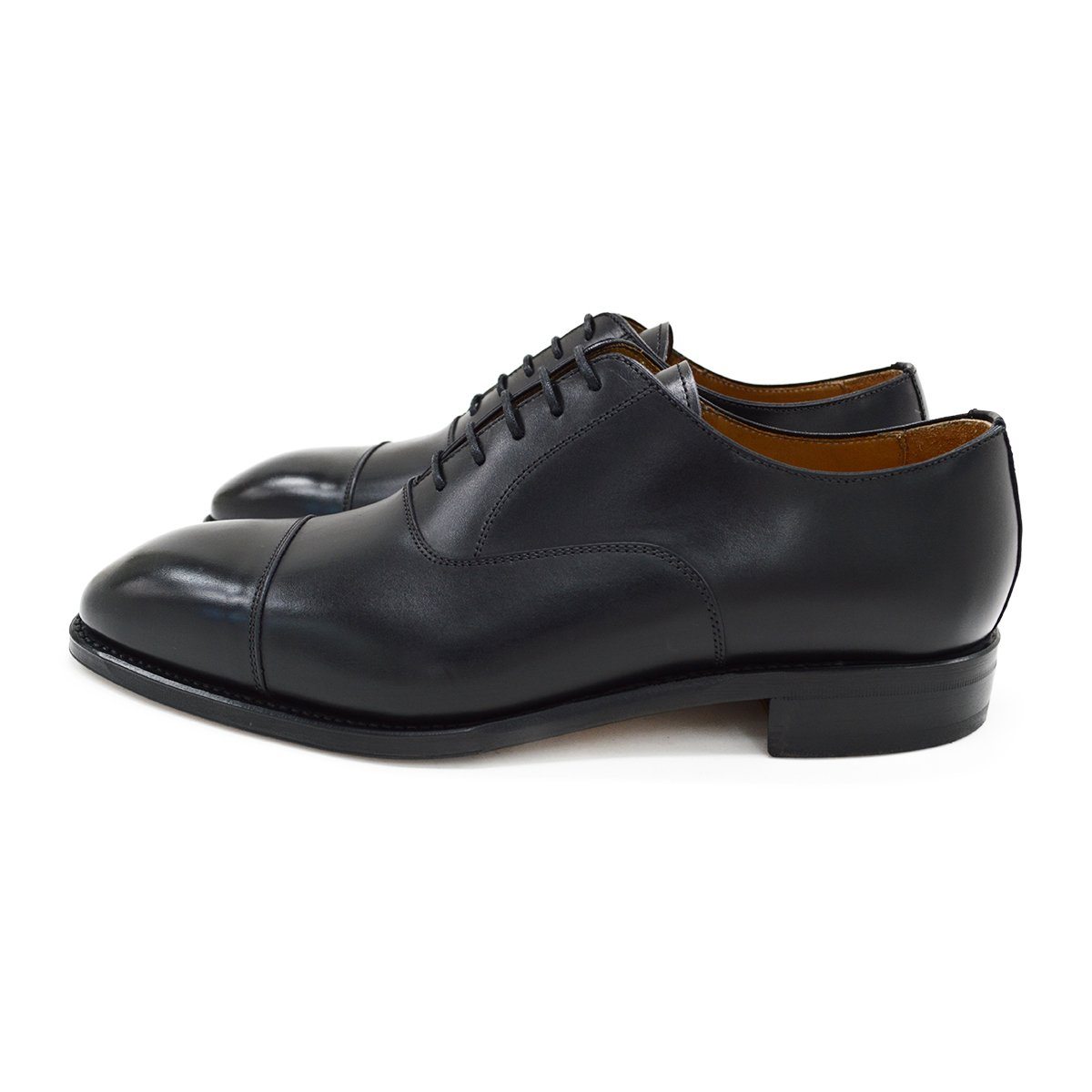 A black, boxcalf leather Oxford shoe with a chisel toe and lace-up closure, crafted in Spain.