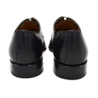 A black, boxcalf leather Oxford shoe with a chisel toe and lace-up closure, crafted in Spain.