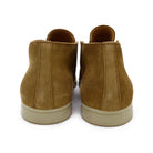 A brown ankle boot made of reverse kudu suede, featuring a low heel and a smooth texture.