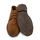 A brown Berwick 1707 5432 Apron Boot with lace-up closure, handcrafted from reverse kudu suede, featuring moccasin stitching and a crepe rubber sole.