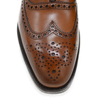 A tan Berwick 1707 Oxford Brogue shoe with intricate brogue detailing and a goodyear welted leather sole.