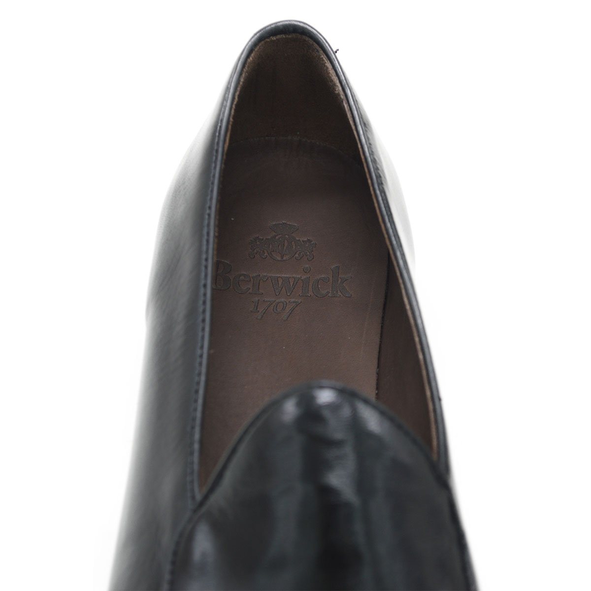 A classic black Berwick 1707 Belgian loafer with a smooth deerskin leather upper, an almond toe shape, and a low heel.
