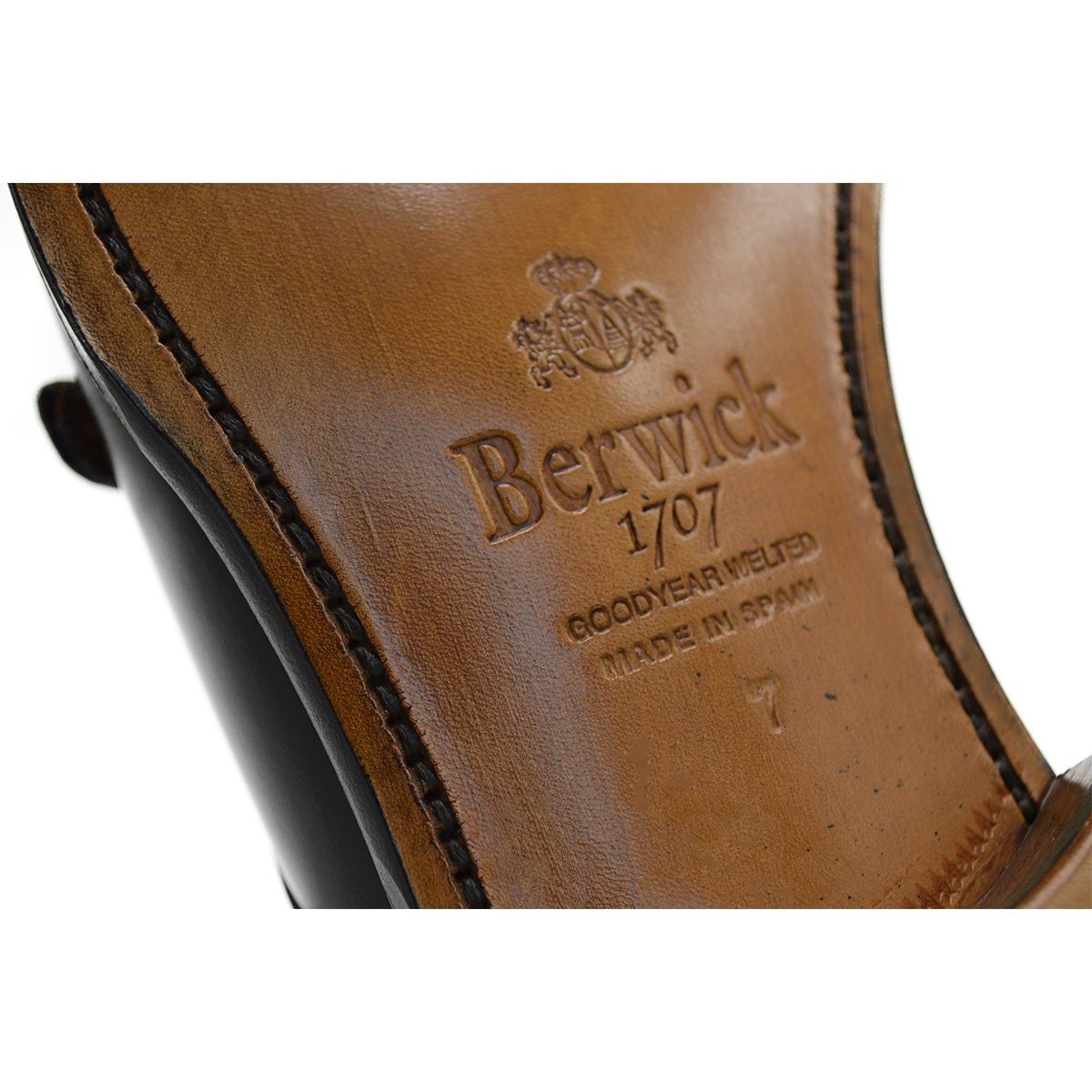 A black, boxcalf leather Oxford shoe with a chisel toe and lace-up closure, crafted in Spain.