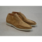 A brown ankle boot made of reverse kudu suede, featuring a low heel and a smooth texture.