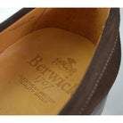 A Berwick 1707 dark brown suede penny loafer with a Goodyear welted leather sole, displayed on a white background.
