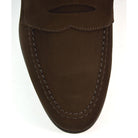 A dark brown suede penny loafer with a Goodyear welted leather sole, displayed on a white background.