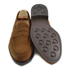 A brown suede penny loafer with a Dainite rubber sole, showing a classic round toe shape and a signature penny slot detail & Dainite Soles