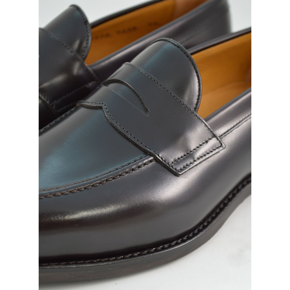 A dark brown Berwick 1707 Penny Loafer with a high-shine finish and a Dainite rubber sole.