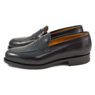 A dark brown Berwick 1707 Penny Loafer with a high-shine finish and a Dainite rubber sole.