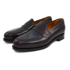 A burgundy high-shine leather penny loafer by Berwick 1707, displaying the classic round toe shape and the brand's distinctive penny slot detail.
