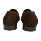 A dark brown suede tassel loafer with a Vegano Moka leather trim, displaying an almond-shaped toe and a fine ridged rubber sole.