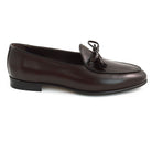A Berwick 1 707 dark brown leather Belgian loafer with a braided leather bow tie and tassel adornment.