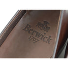 A Berwick 1 707 dark brown leather Belgian loafer with a braided leather bow tie and tassel adornment.
