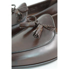 A Berwick 1 707 dark brown leather Belgian loafer with a braided leather bow tie and tassel adornment.