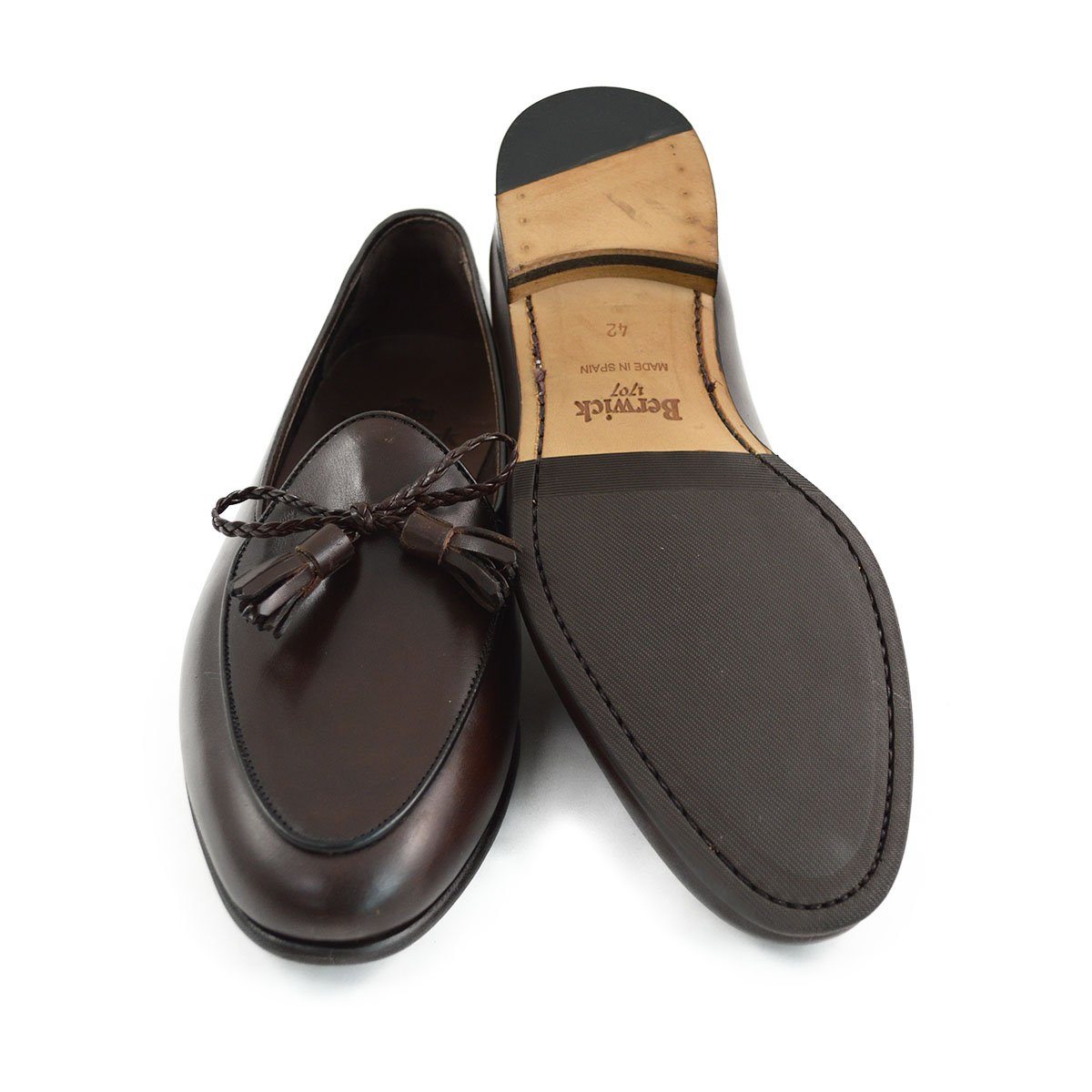 A Berwick 1 707 dark brown leather Belgian loafer with a braided leather bow tie and tassel adornment.