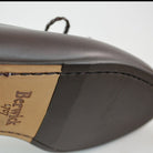 A Berwick 1 707 dark brown leather Belgian loafer with a braided leather bow tie and tassel adornment.