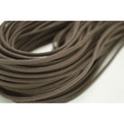 A close-up image of a dark brown waxed shoelace with a focus on its texture and weave.