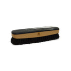 A handcrafted shoe polishing brush with a black and white oxhorn handle and dark bristles, presented on a plain background.