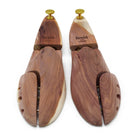 A Berwick 1707 cedar wood shoe tree with brass fitments, displayed in an open position showing the interior structure.