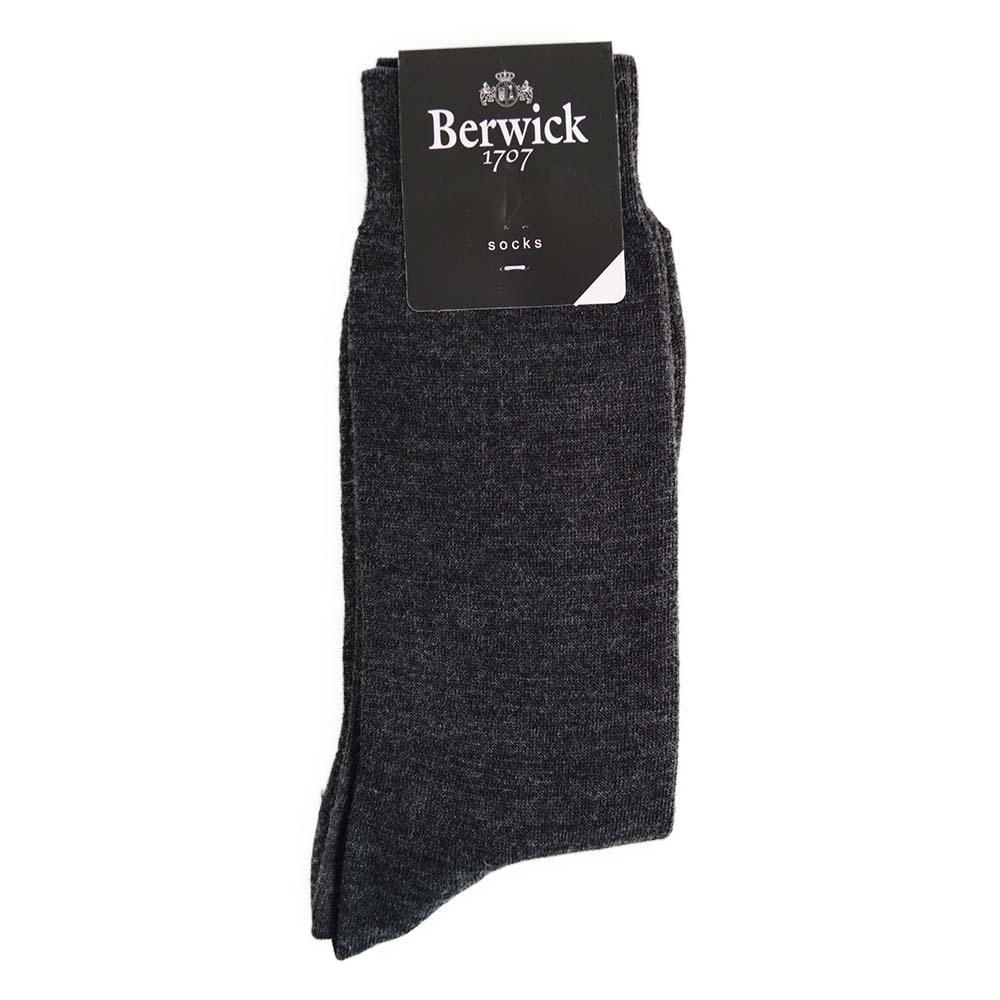 A pair of grey plain knit socks with the Berwick 1707 brand tag visible.