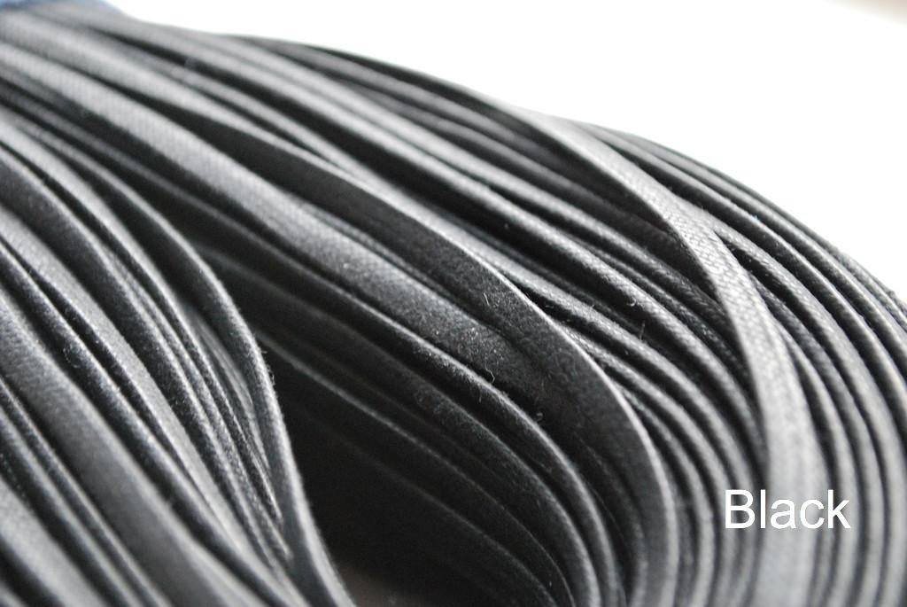 A close-up image of a waxed round brown shoe lace.
