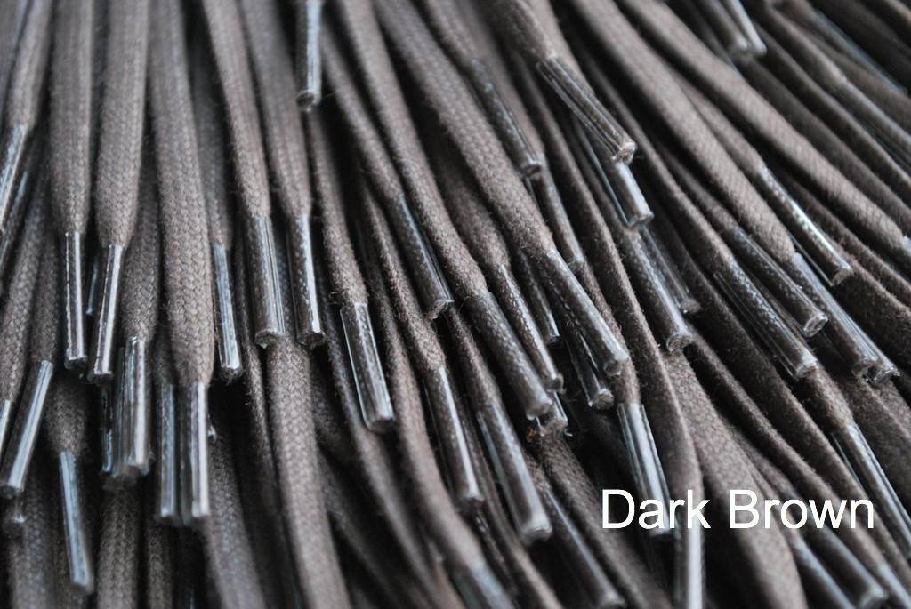 A close-up image of a waxed round brown shoe lace.