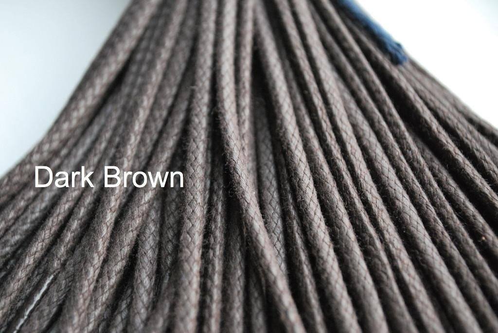 A close-up image of a waxed round brown shoe lace.