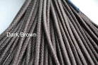 A close-up image of a waxed round brown shoe lace.