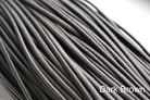 A close-up of a brown waxed round dress shoe lace.