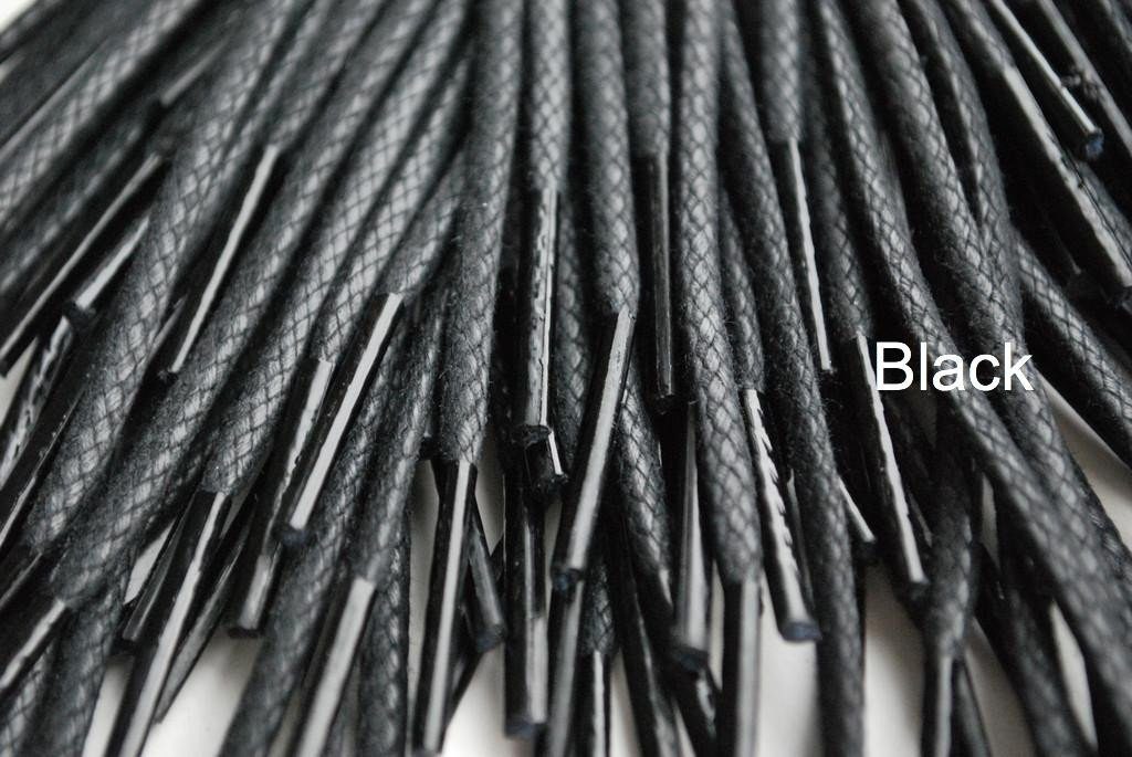 A close-up image of a waxed round brown shoe lace.