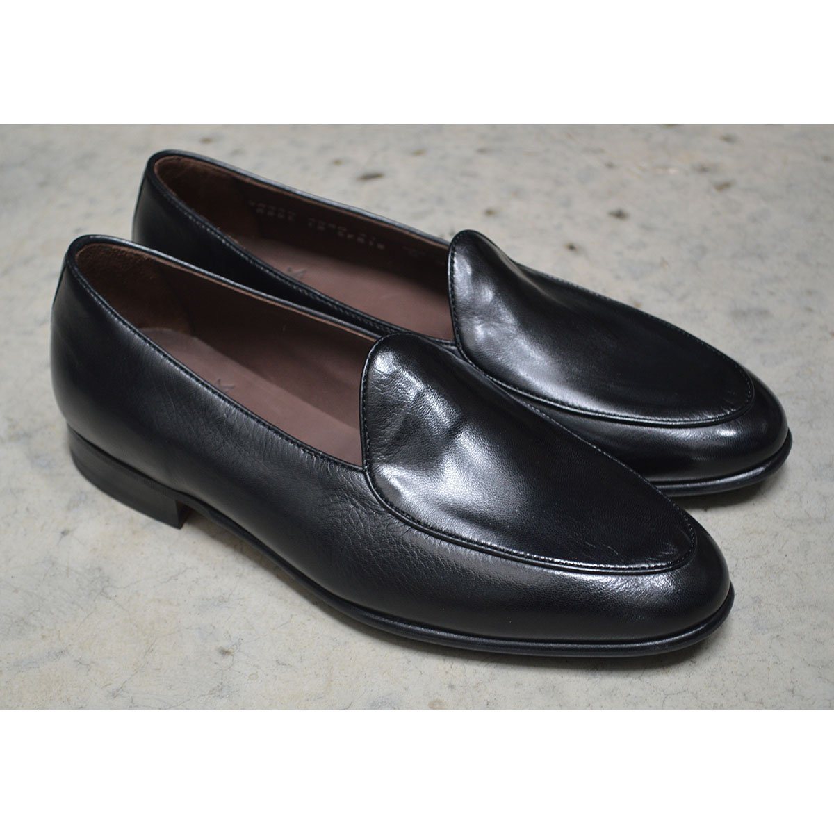 A classic black Berwick 1707 Belgian loafer with a smooth deerskin leather upper, an almond toe shape, and a low heel.