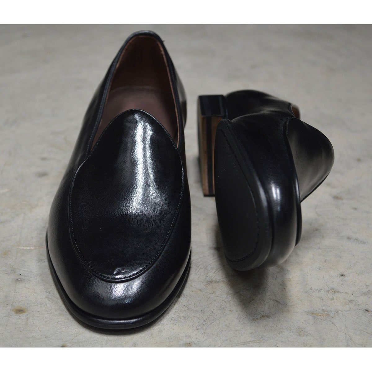 A classic black Berwick 1707 Belgian loafer with a smooth deerskin leather upper, an almond toe shape, and a low heel.