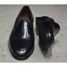 A classic black Berwick 1707 Belgian loafer with a smooth deerskin leather upper, an almond toe shape, and a low heel.