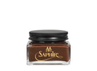 A glass jar with a black lid labeled 'SAPHIR' containing cream shoe polish.