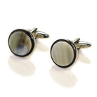 A pair of round Abbeyhorn cufflinks with a rhodium finish and patterned Oxhorn surface, displayed against a white background.