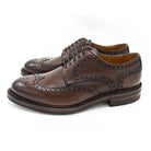 A Berwick 1707 brown brogue derby shoe with a round toe shape and lace-up closure. It features a grainy texture and brogue detailing & Dainite soles