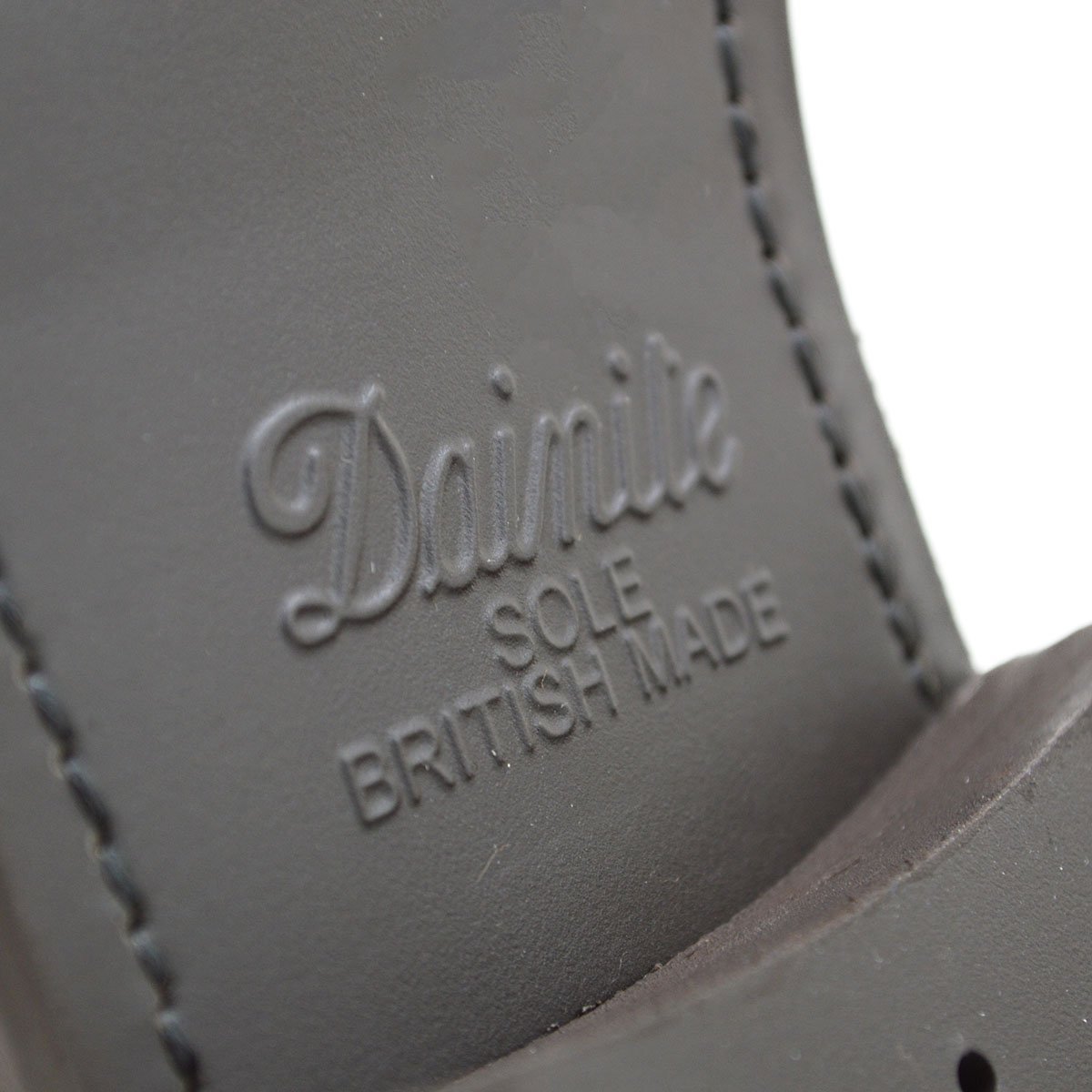 A Berwick 1707 brown brogue derby shoe with a round toe shape and lace-up closure. It features a grainy texture and brogue detailing & Dainite soles