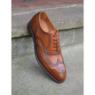 A tan Berwick 1707 Oxford Brogue shoe with intricate brogue detailing and a goodyear welted leather sole.
