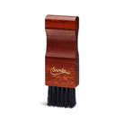 A crepe suede brush with a beige bristle head and a brown exotic wood handle.