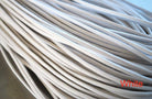 A close-up of a white waxed round dress shoe lace.